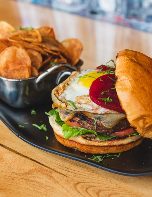 Delicious meat burger served with chips