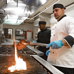 chef grilling chicken on grill