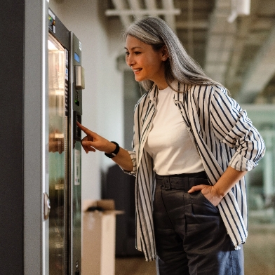 Woman using a vending machine