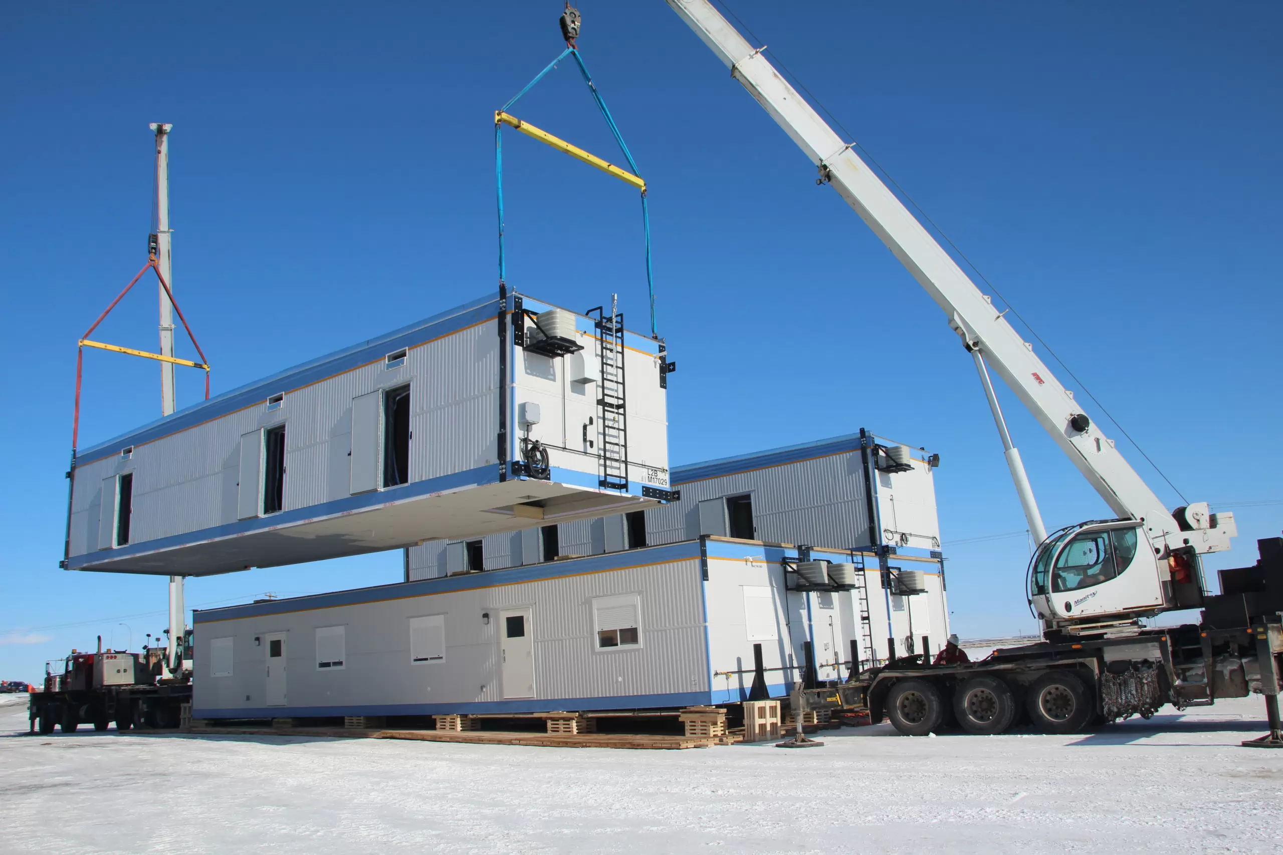 storage container being lifted by crane