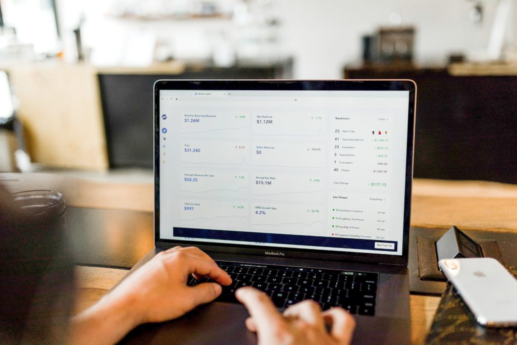 A laptop is shown with numbers and percentages