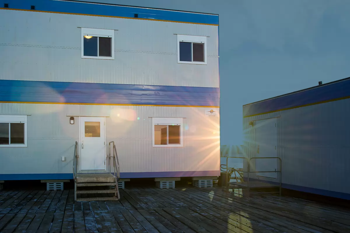 Une prise de vue extérieure d’un pavillon au lever du soleil