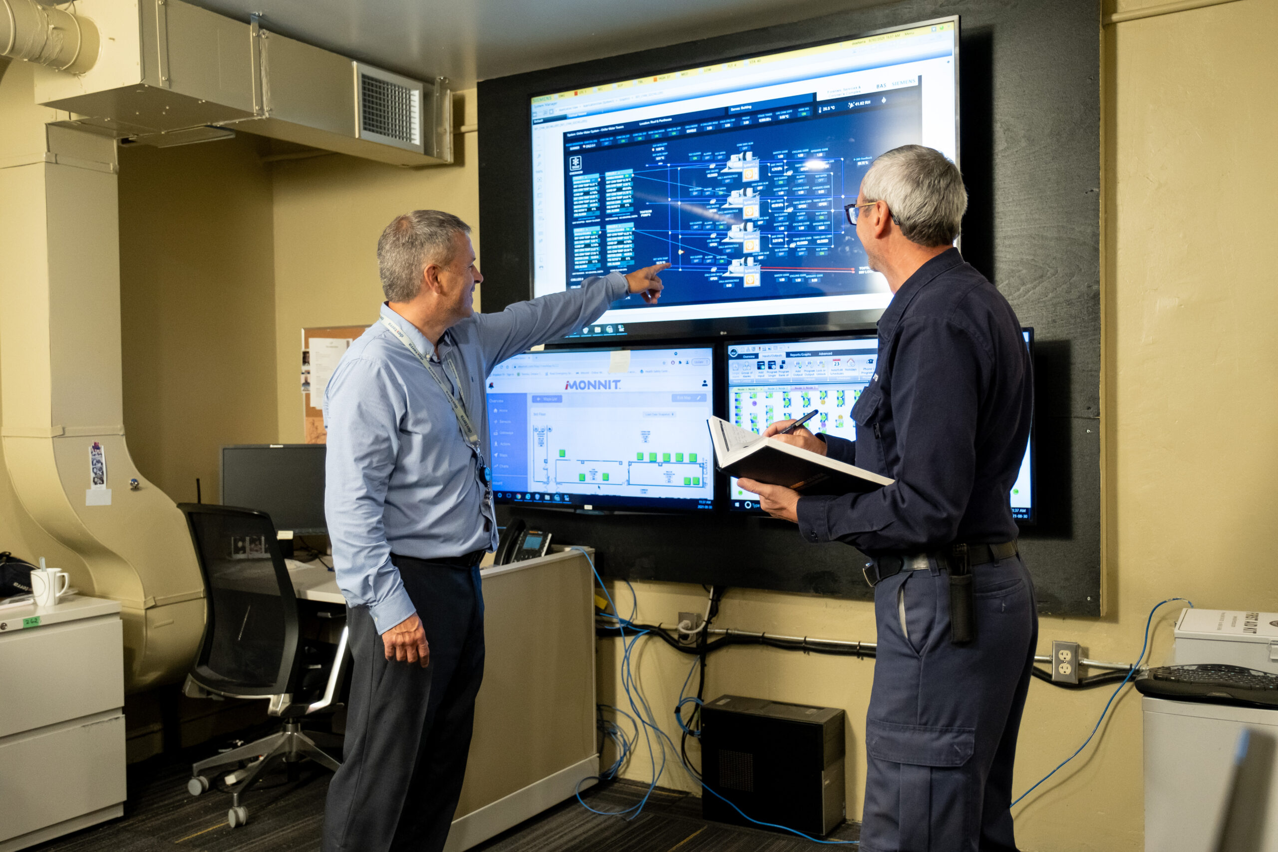Man pointing at screen showing facility operations graphic